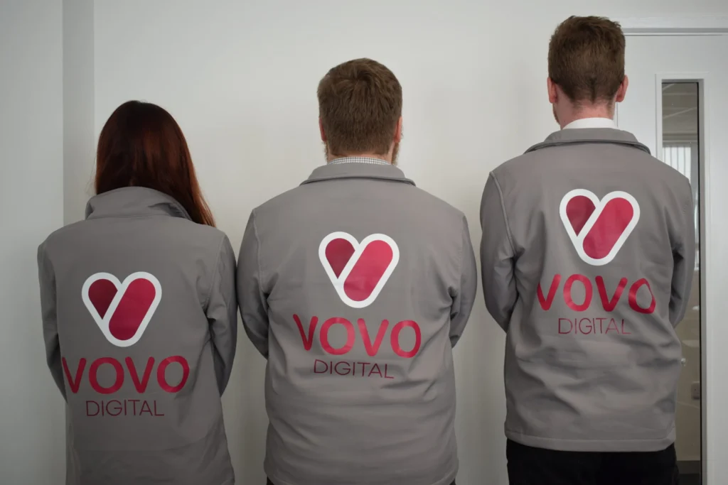 Hilly, Matthew, and Ellis showing off the back of their VOVO digital jackets.
