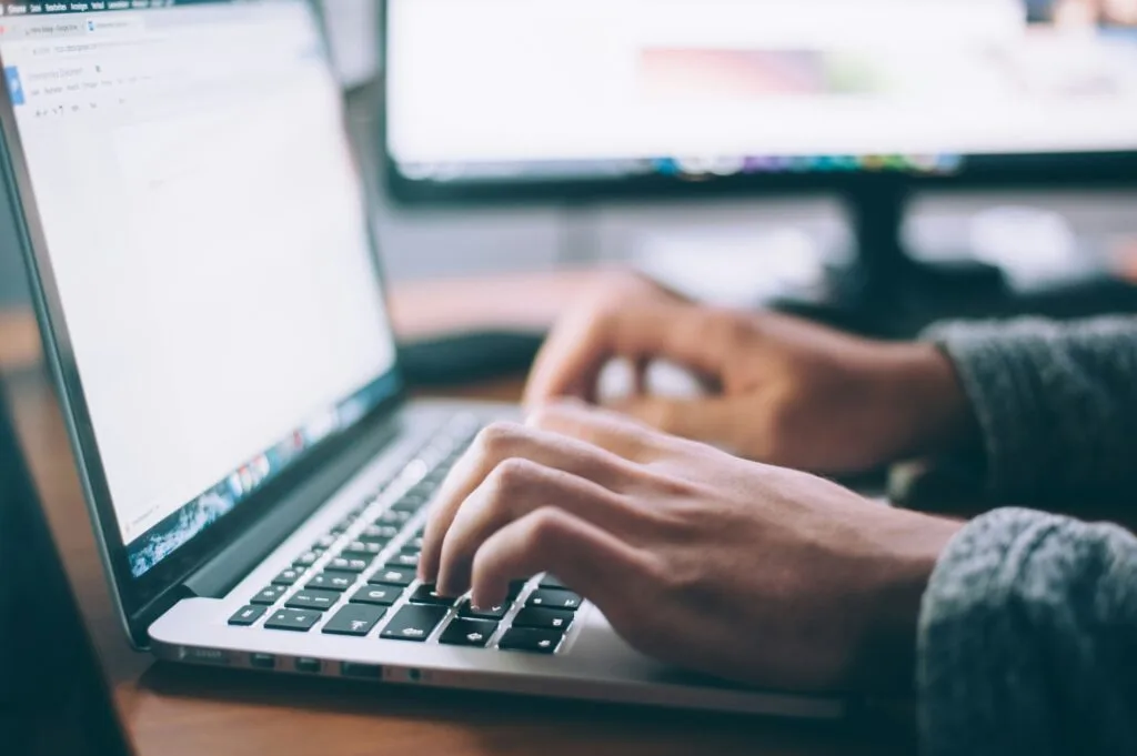 person typing on laptop representing domain authority