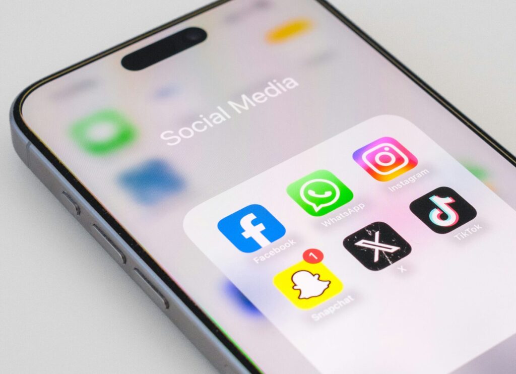phone with social media apps in folder