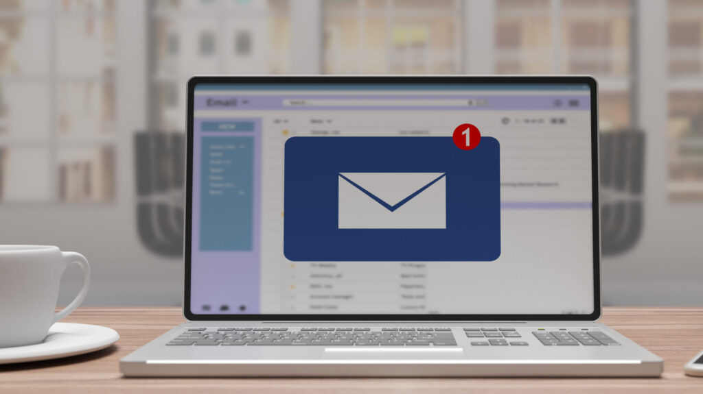 Email message inbox notification on laptop screen, business back